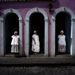 Brazil, Cachoeira, Salvador da Bahia. Three Irmanas (Sisters) stand at the entrance to the seat of the Irmandade da Boa Morte (Sisterhood of the Good Death). 