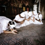 Brazil, Cachoeira, Salvador da Bahia. Filhas do Santo (Children of the Saint) welcome Mai Maddalena, the leader of their group, at the beginning of a Candomble ceremony.