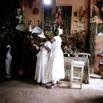 Brazil, Cachoeira, Salvador da Bahia. Two woman help each other with their head scarfs at a Candomble Terreiro (Temple).