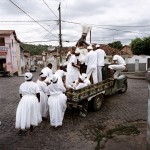 Brazil, Cachoeira, Salvador da Bahia. Worshippers from the branch, or nation (nacoe), of Candomble known as Candomble do Caboclo. The term Caboclo, aside from being a term to describe a person of mixed Brazilian Amerindian and European descent, is also used as an alternate term for certan orixas (gods) of the Candomble religion. The caboclo, that can be seen here on the truck, is also an orixa.