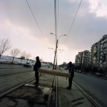 Romania, Bucharest. Gheo and Florin collecting a bed to be burnt as firewood.