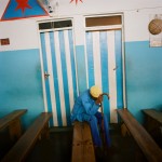 Mozambique, Maputo. A man prays in the Zion church, Igreja Apostolica Betel.